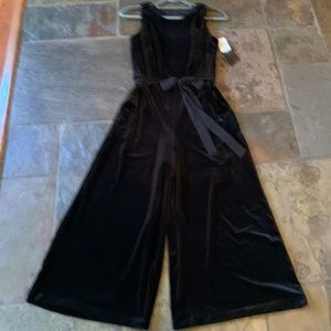 Beautiful black velvet jumpsuit with exposed zipper down back w/unusual cutouts.